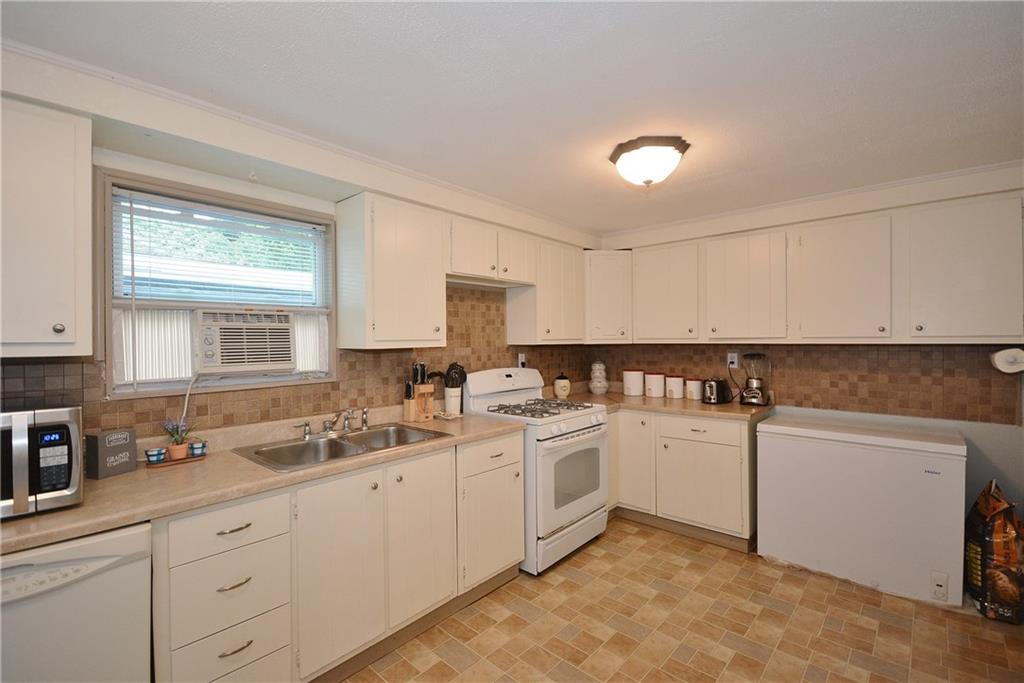 8239 Nadine Road Verona, PA 15147 - Photo 11 of 25 Lots of cabinets and plenty of counter space for cooking. Notice built-in dishwasher.