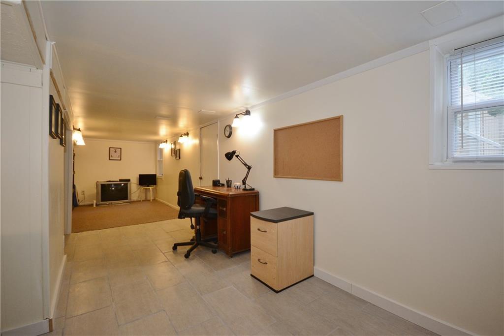 8239 Nadine Road Verona, PA 15147 - Photo 18 of 25 Versatile area in basement. Game room, office, lots of possibilities. Notice lovely ceramic just installed.