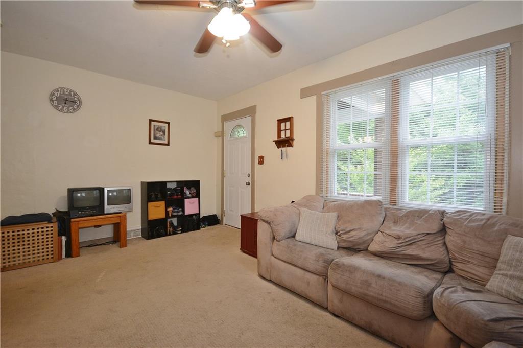 8239 Nadine Road Verona, PA 15147 - Photo 4 of 25 Enter into spacious living room with lots of natural light shining through newer windows