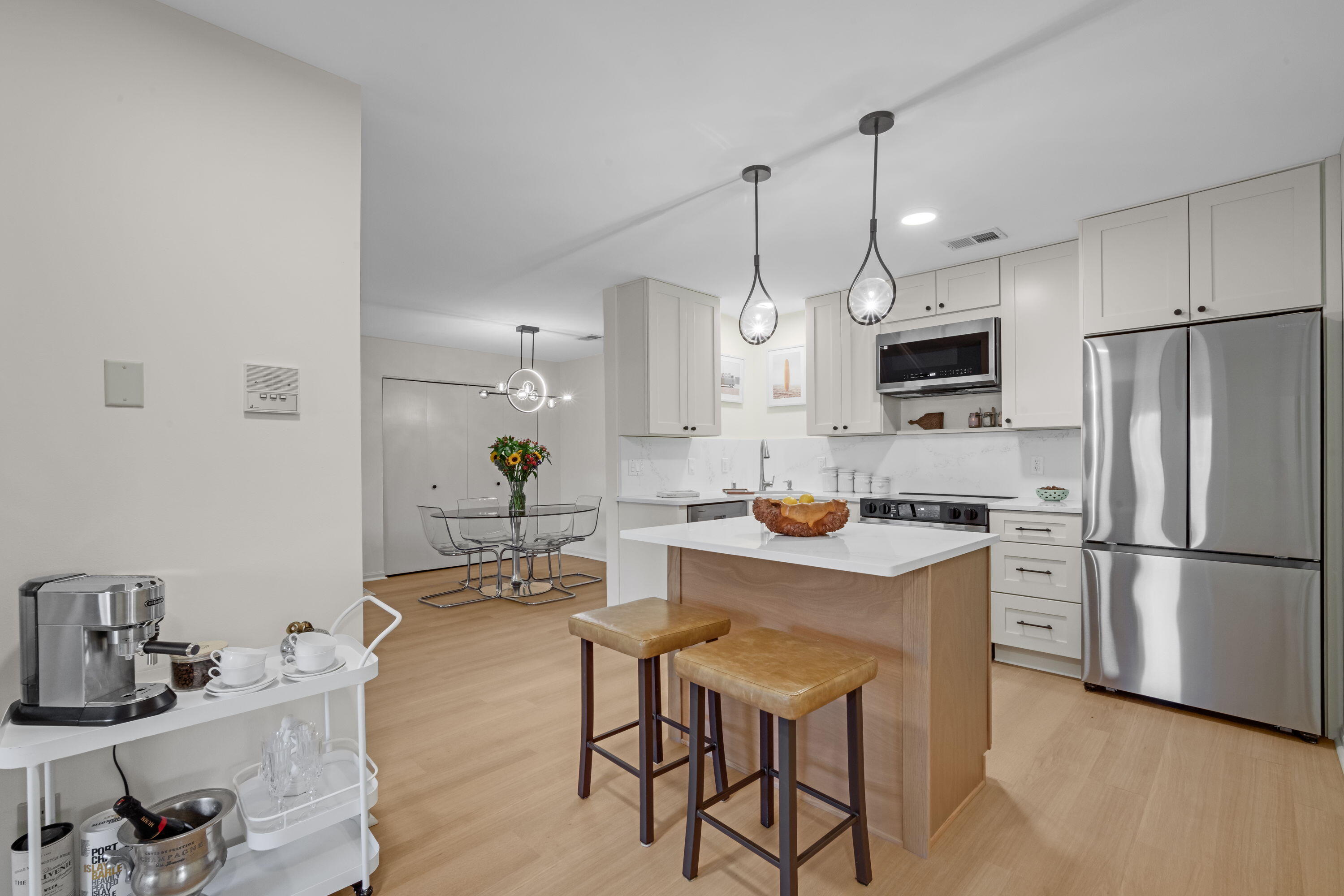 A clean, modern kitchen that opens comfortably into the living space. Fresh finishes and warm light give it a welcoming feel.