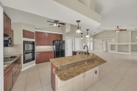 a bathroom with a granite countertop sink a mirror and a bathtub