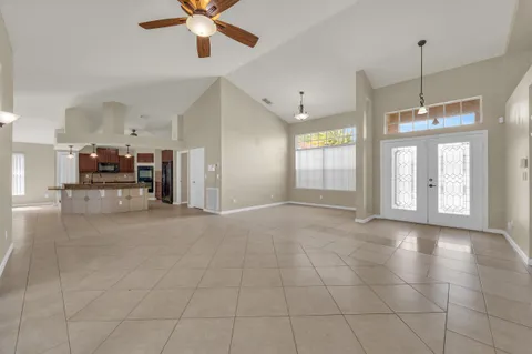a large kitchen with granite countertop a sink a counter space stainless steel appliances and cabinets