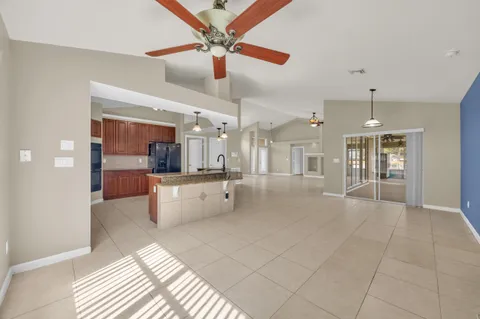a kitchen with stainless steel appliances granite countertop a sink and a refrigerator