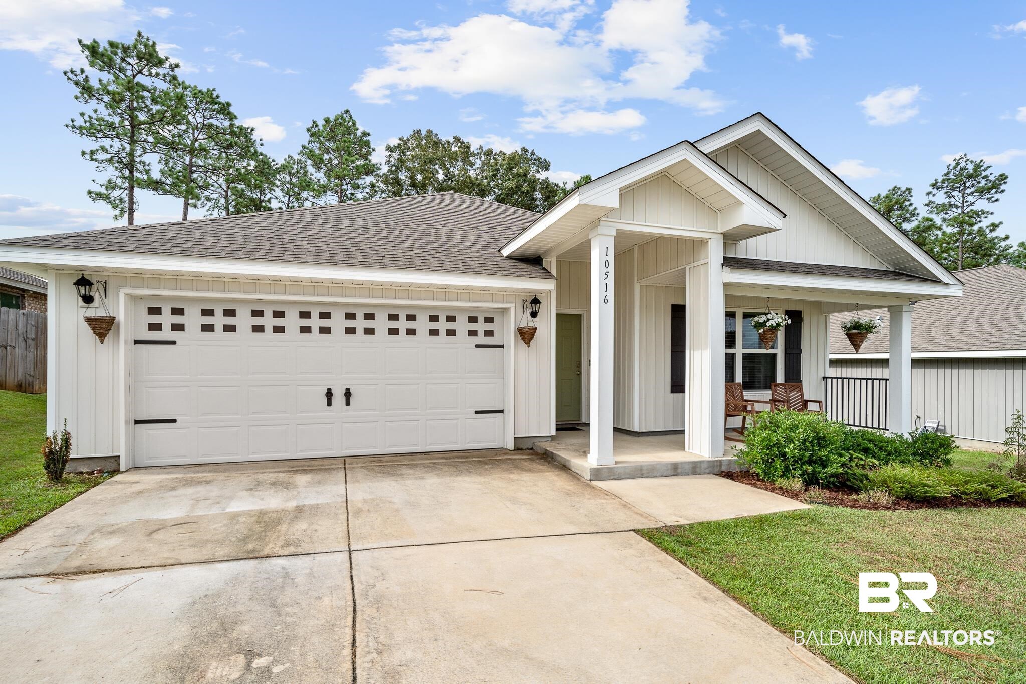 10516 Brodick Loop Daphne, AL 36527 - Photo 3 of 27 View of front of house featuring covered porch, a garage, and a front lawn