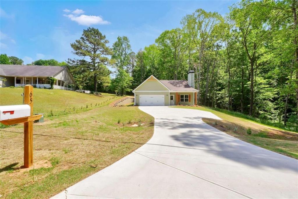65 Lakeside Drive Covington, GA 30016 - Photo 1 of 35 a front view of a house with a yard