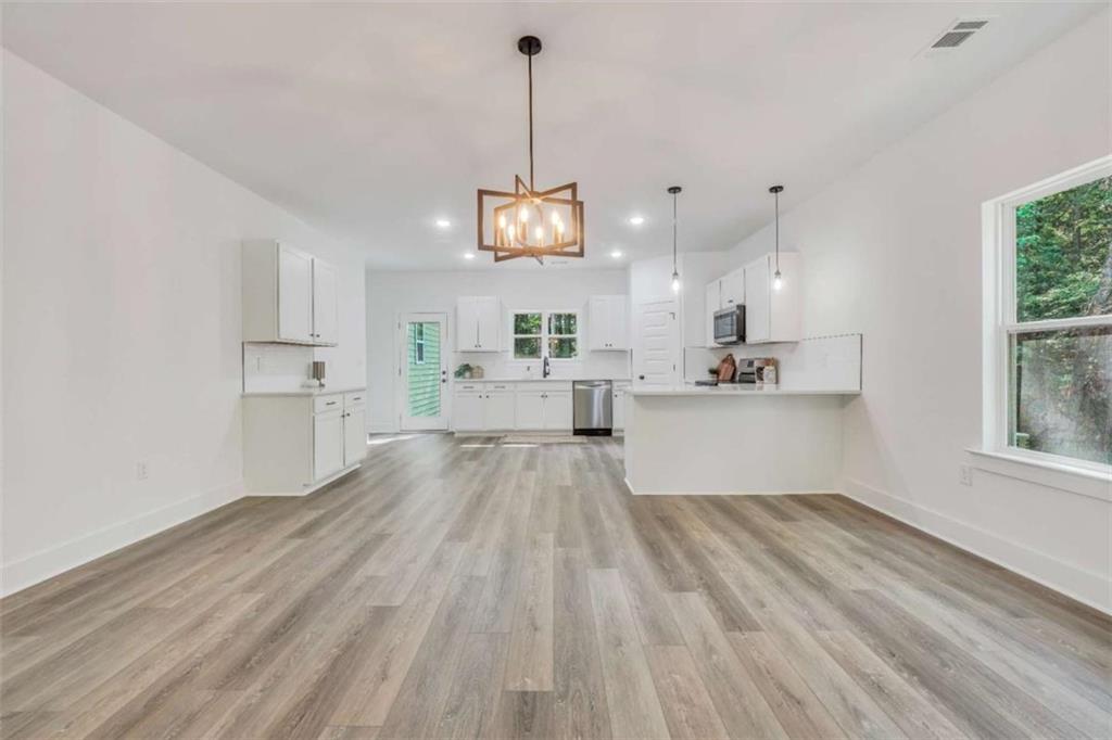 65 Lakeside Drive Covington, GA 30016 - Photo 11 of 35 a view of a kitchen with wooden floor and windows
