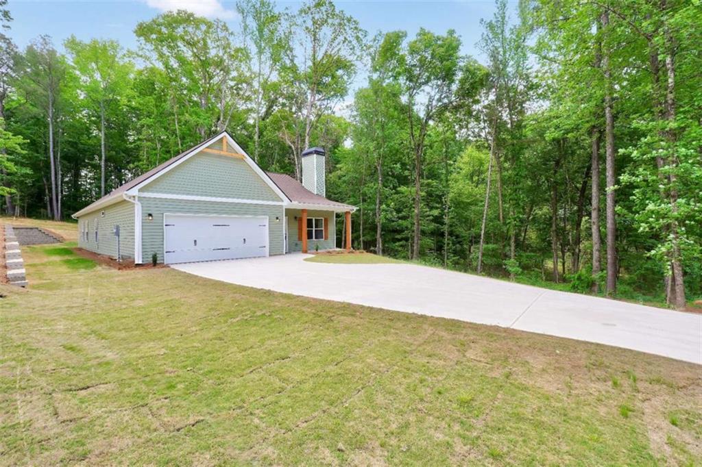 65 Lakeside Drive Covington, GA 30016 - Photo 2 of 35 a front view of house with yard and trees in the background