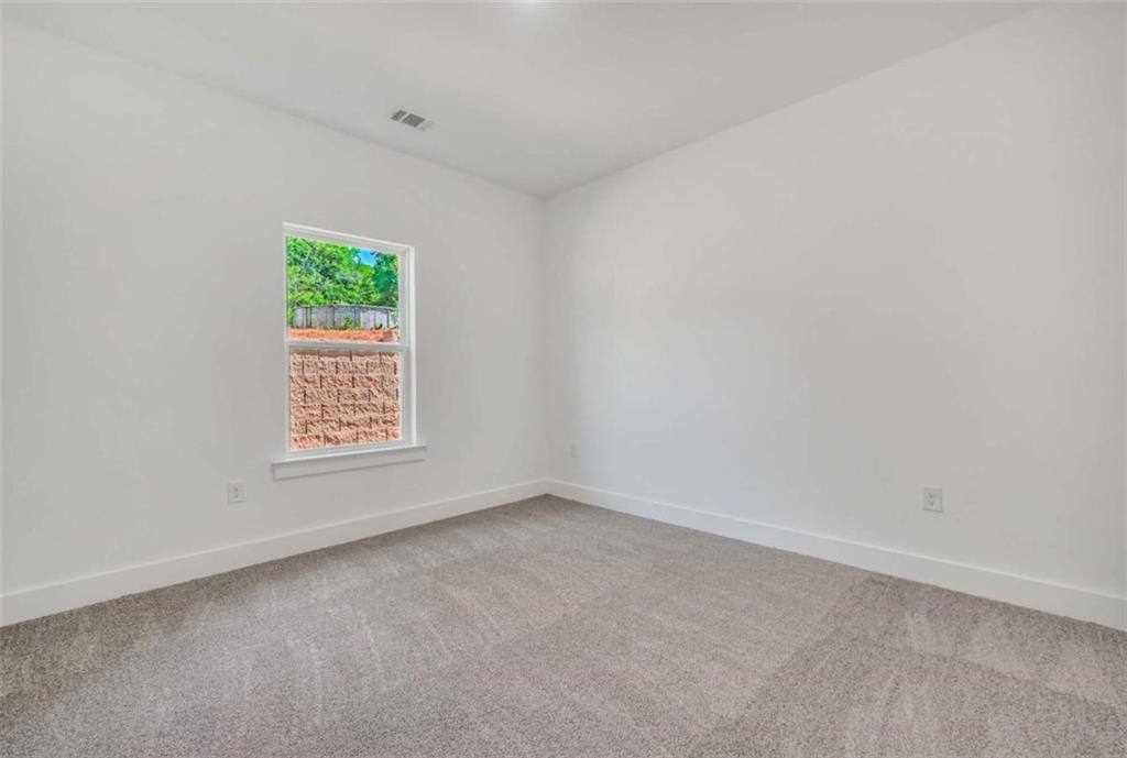 65 Lakeside Drive Covington, GA 30016 - Photo 23 of 35 a view of an empty room with a window