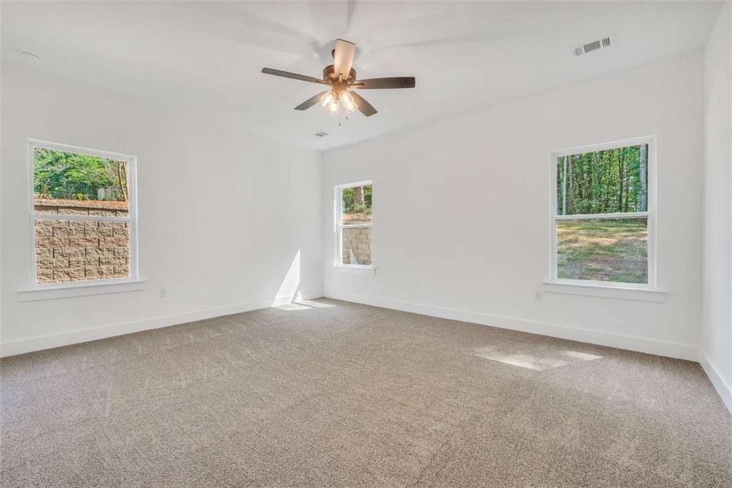 65 Lakeside Drive Covington, GA 30016 - Photo 26 of 35 an empty room with windows and fan