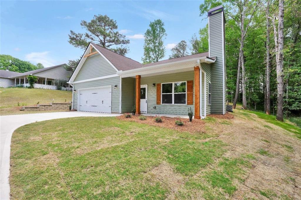 65 Lakeside Drive Covington, GA 30016 - Photo 3 of 35 a house with trees in front of it