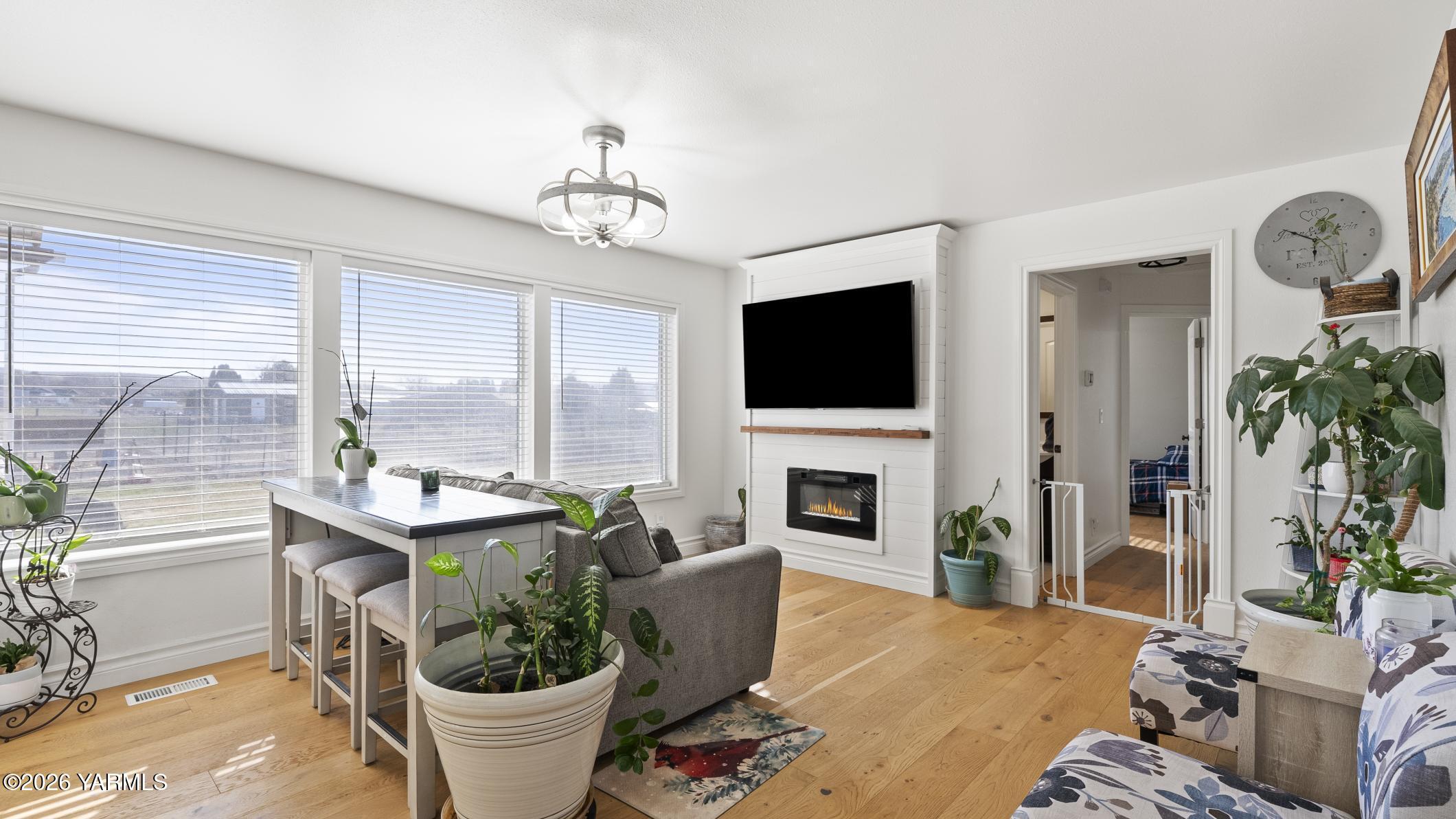 471 Gibson Road Selah, WA 98942 - Photo 2 of 13 a living room with furniture a flat screen tv and a fireplace