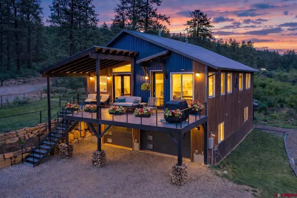 a view of a house with backyard porch and sitting area