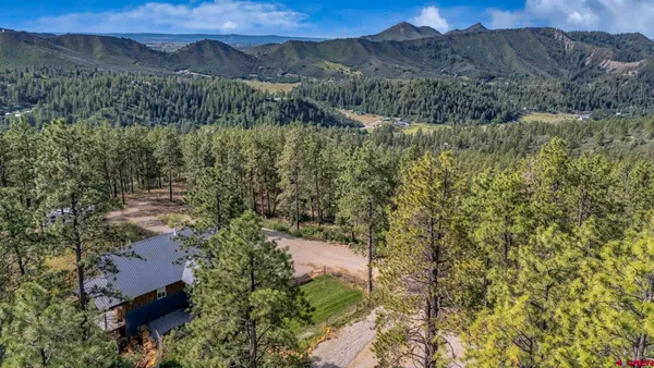 a en suite bathroom with a granite countertop tub and a double vanity sink