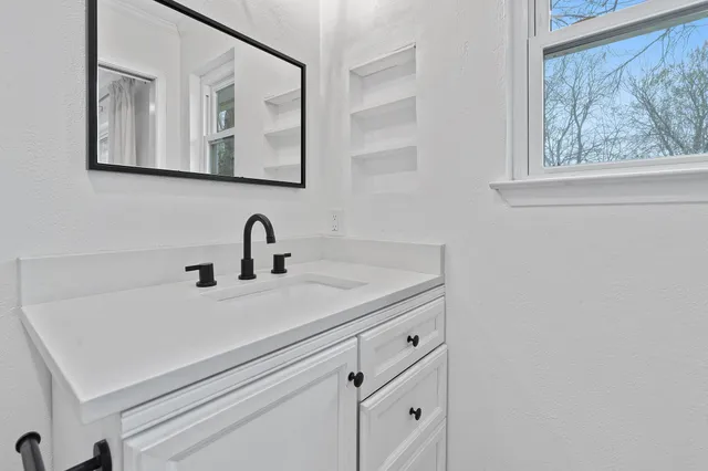a bathroom with a sink and a mirror