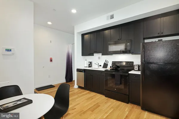 a kitchen with stainless steel appliances a refrigerator stove and microwave