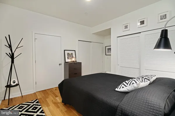 a bedroom with a bed and a potted plant