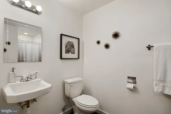 a bathroom with a sink mirror and toilet
