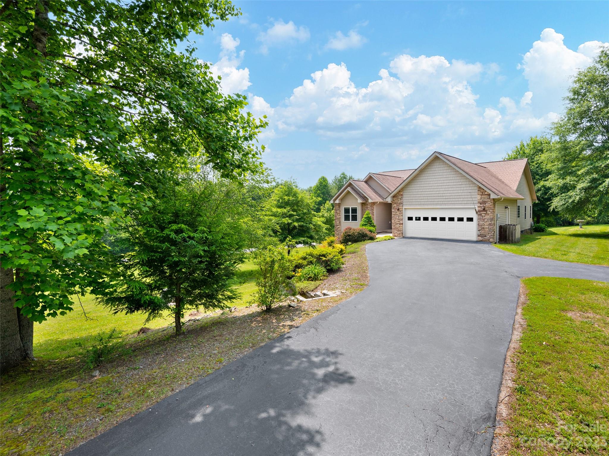 1223 North Ridge Road Hendersonville, NC 28792 - Photo 1 of 24 a view of an house with backyard space and garden