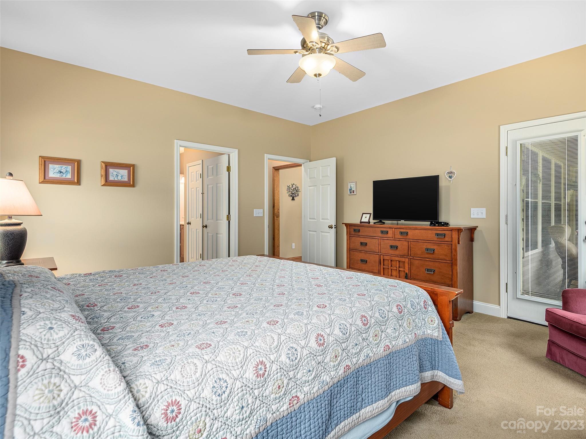 1223 North Ridge Road Hendersonville, NC 28792 - Photo 13 of 24 a bedroom with a bed and a flat screen tv