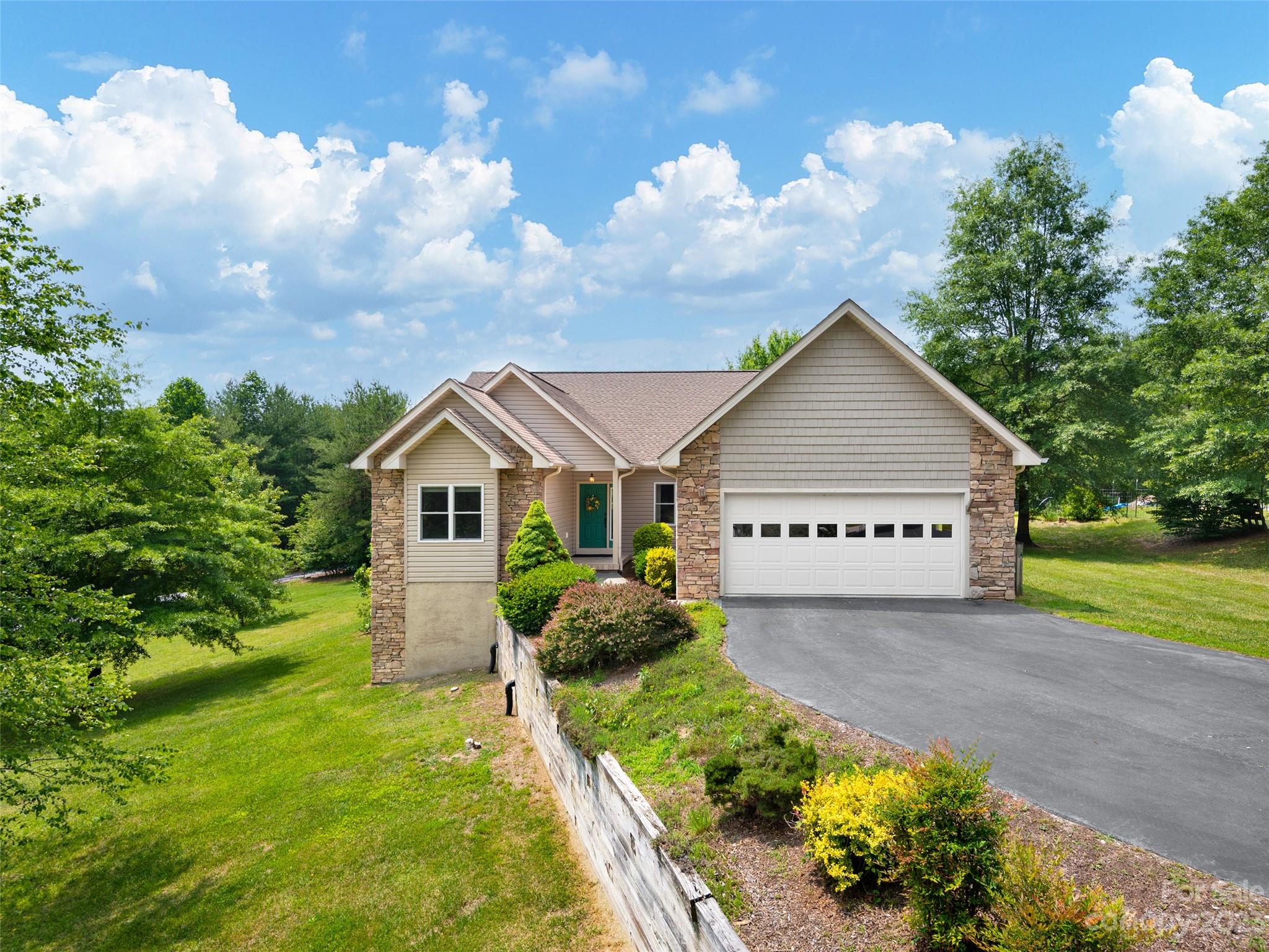 1223 North Ridge Road Hendersonville, NC 28792 - Photo 2 of 24 a house with green field in front of it