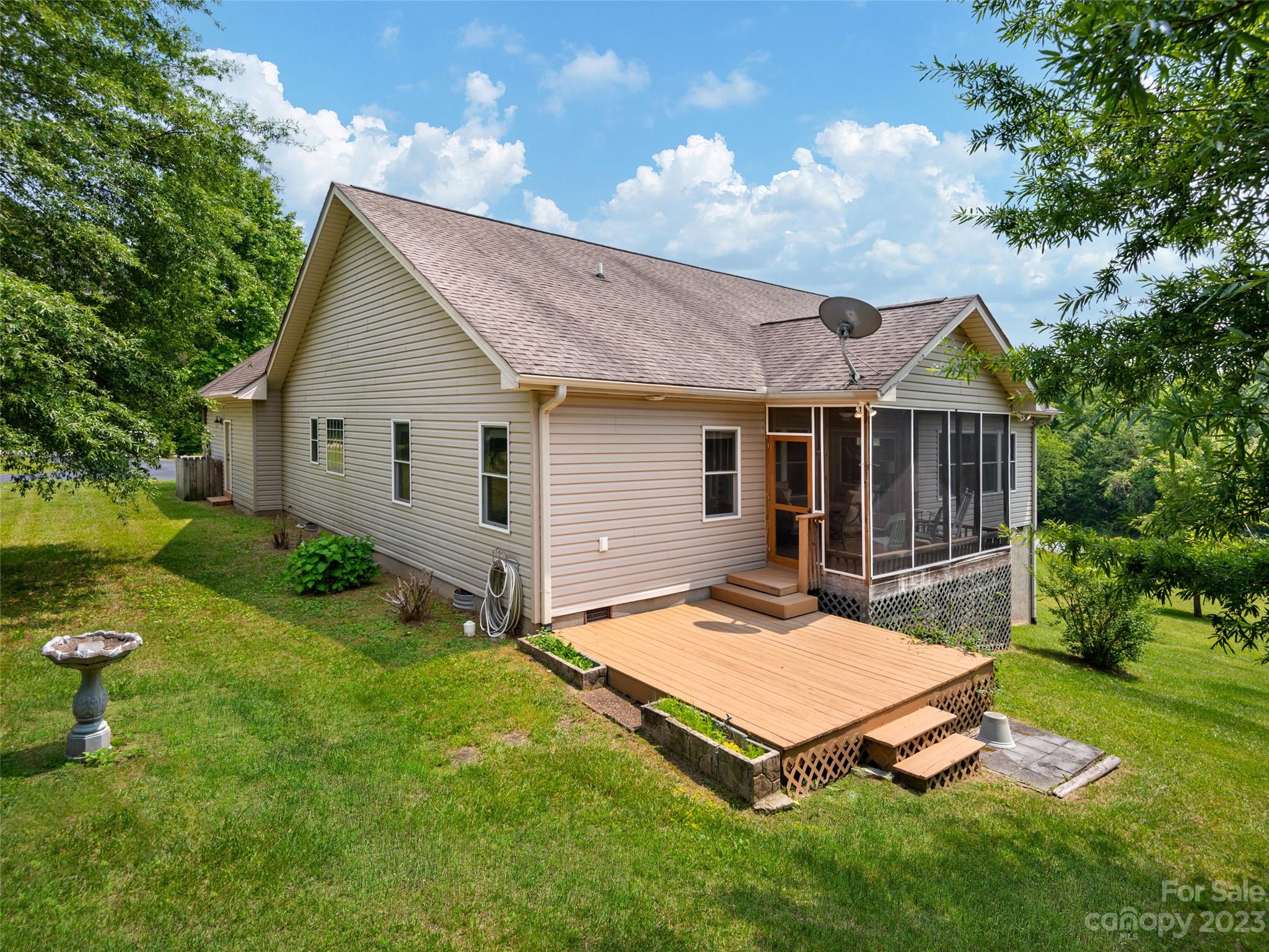 1223 North Ridge Road Hendersonville, NC 28792 - Photo 23 of 24 a backyard of a house with table and chairs