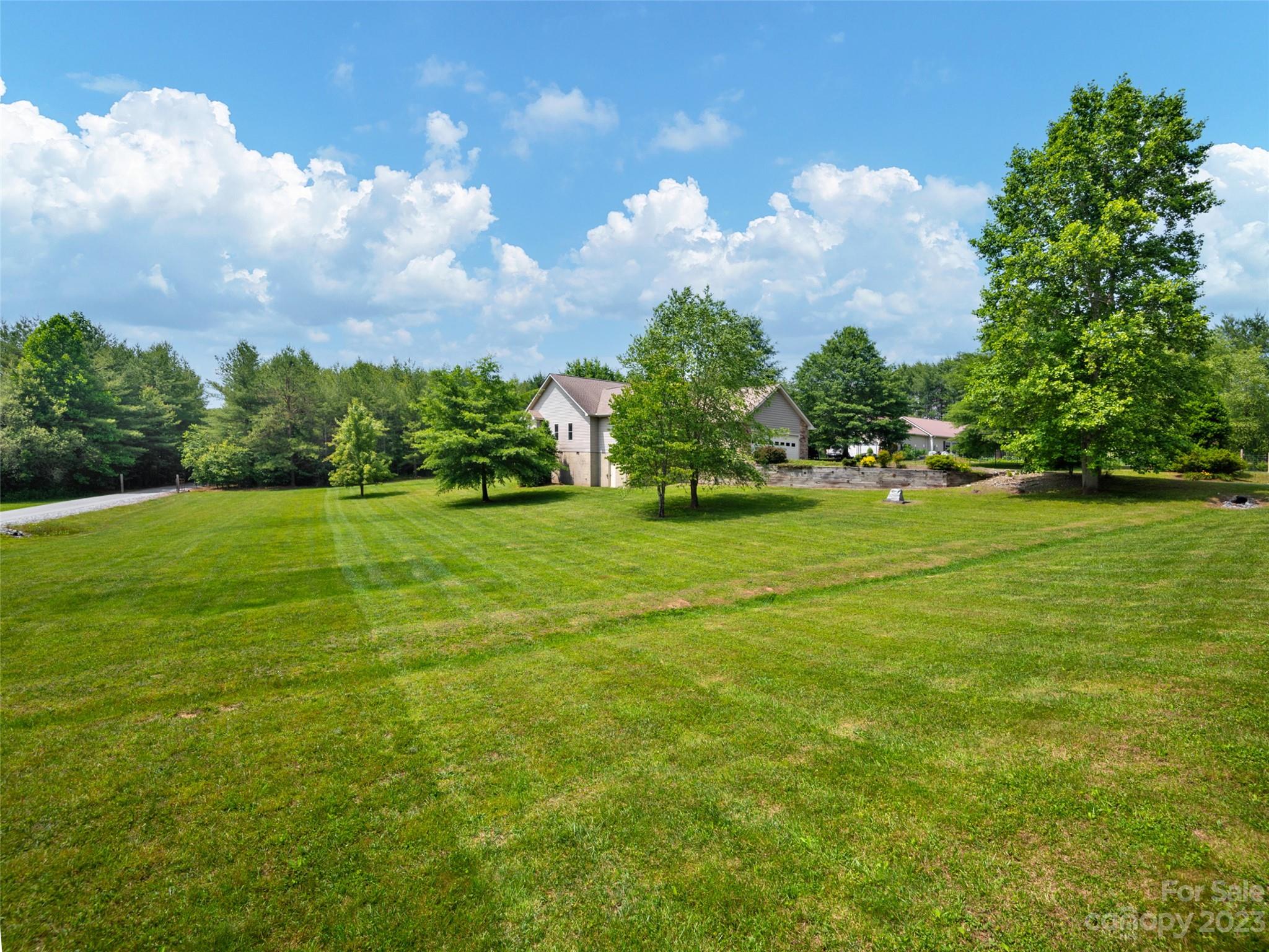 1223 North Ridge Road Hendersonville, NC 28792 - Photo 3 of 24 a view of a golf course with a big yard