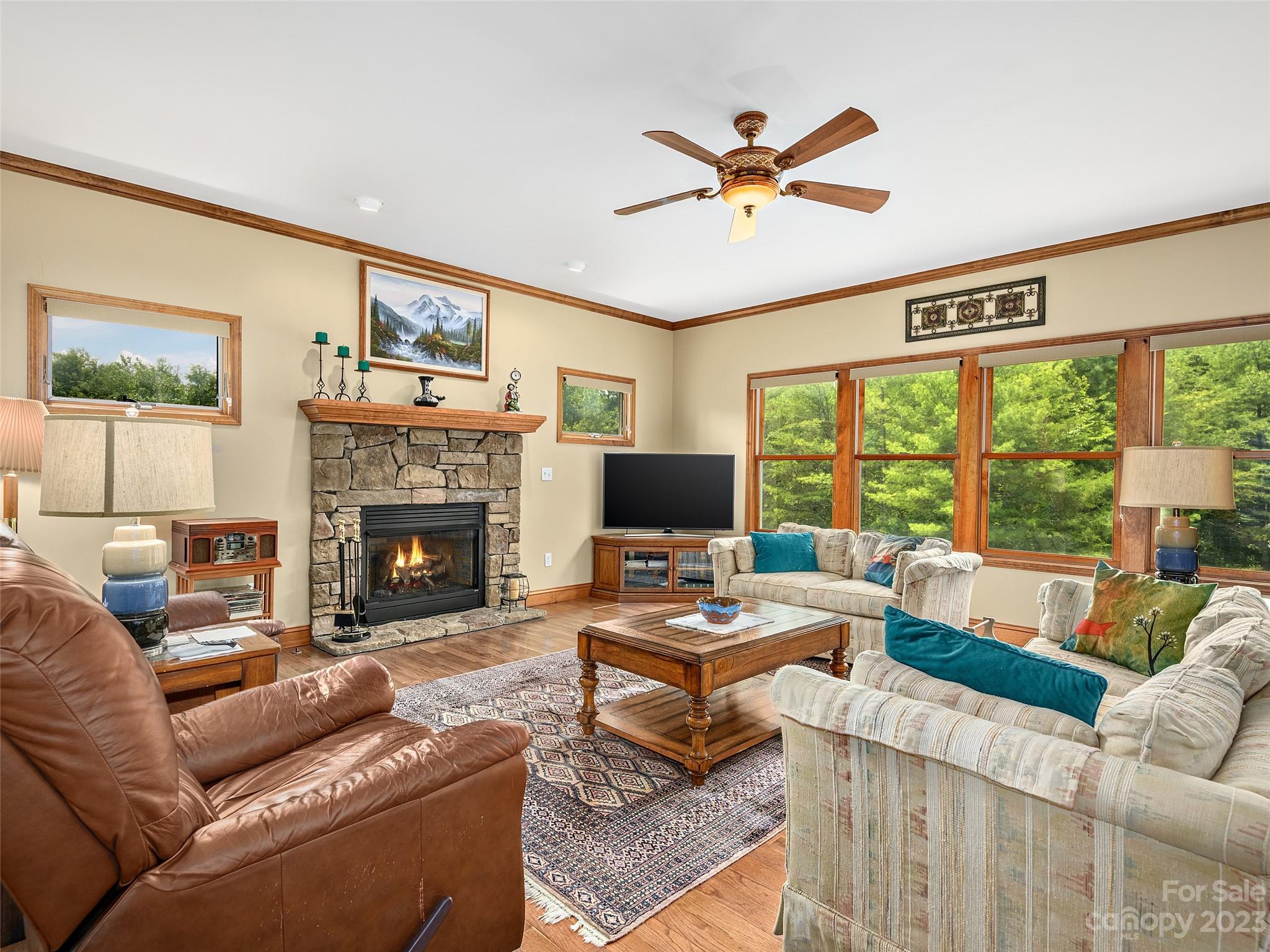 1223 North Ridge Road Hendersonville, NC 28792 - Photo 6 of 24 a living room with furniture a fireplace and a large window