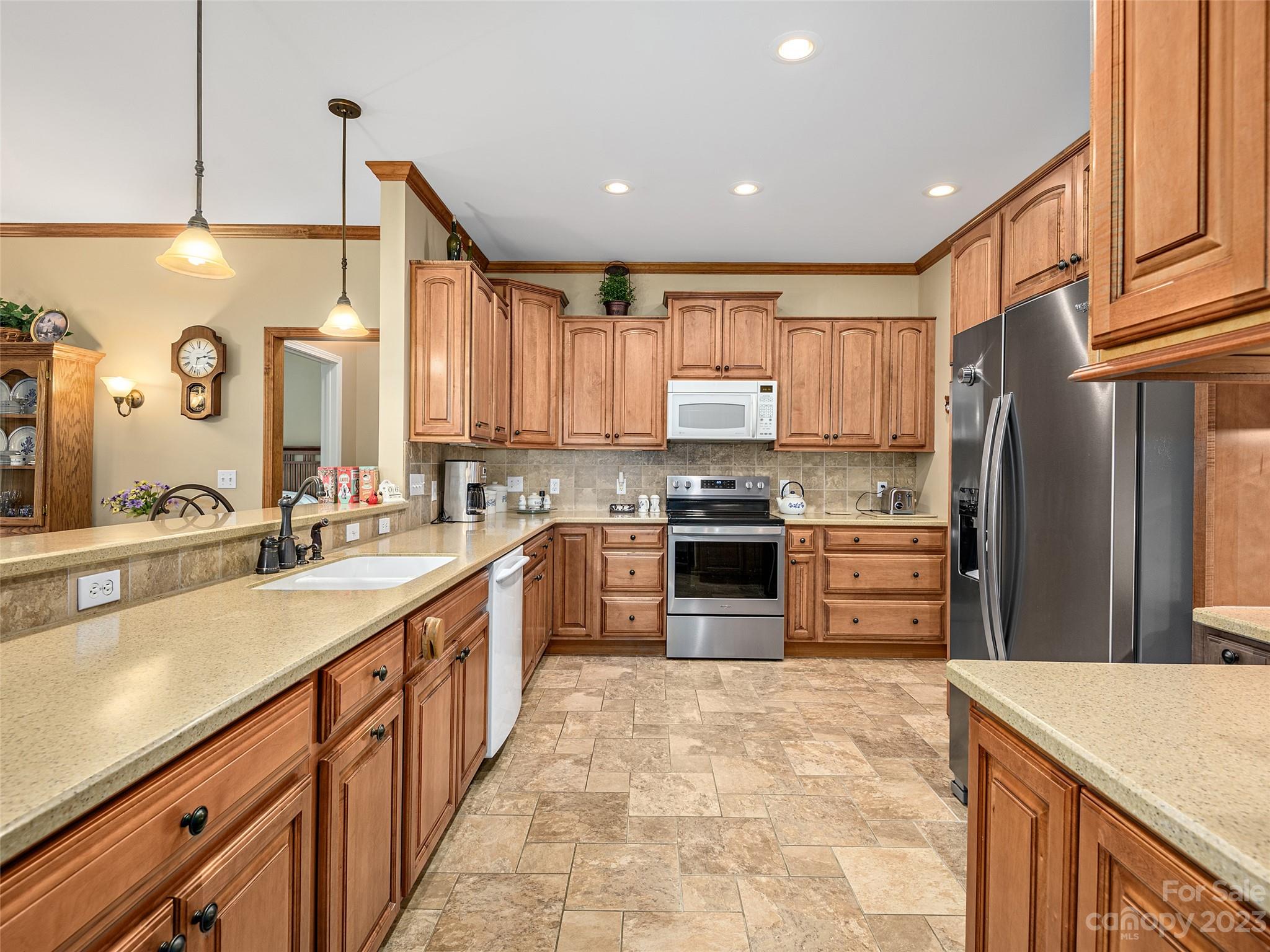 1223 North Ridge Road Hendersonville, NC 28792 - Photo 10 of 24 a large kitchen with stainless steel appliances and a kitchen island