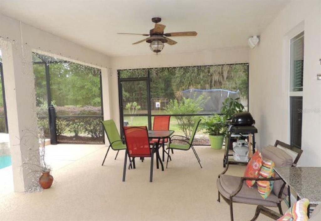14228 Northwest 23 Lane Gainesville, FL 32606 - Photo 13 of 17 a dining room with furniture and a floor to ceiling window