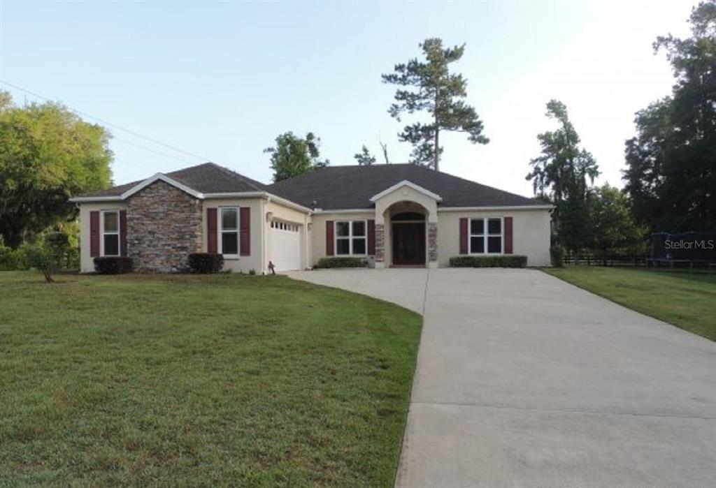 14228 Northwest 23 Lane Gainesville, FL 32606 - Photo 16 of 17 a front view of a house with a garden