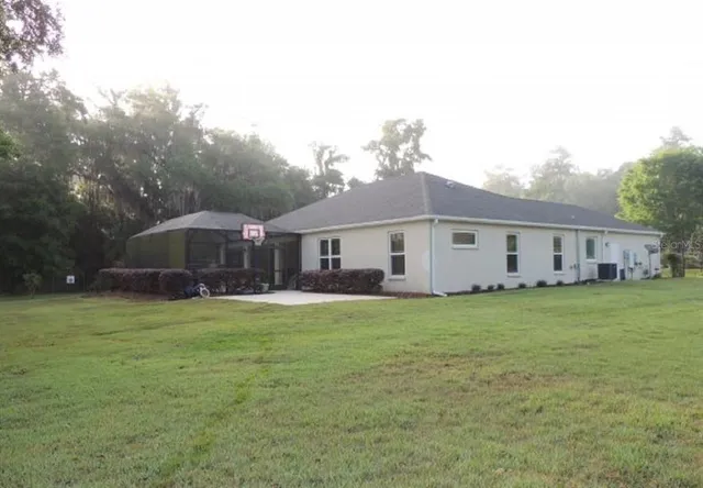 a view of a house with a back yard