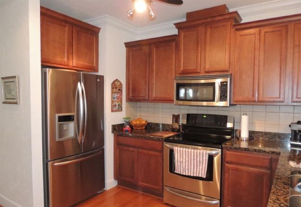 14228 Northwest 23 Lane Gainesville, FL 32606 - Photo 2 of 17 a kitchen with stainless steel appliances granite countertop a refrigerator stove and microwave