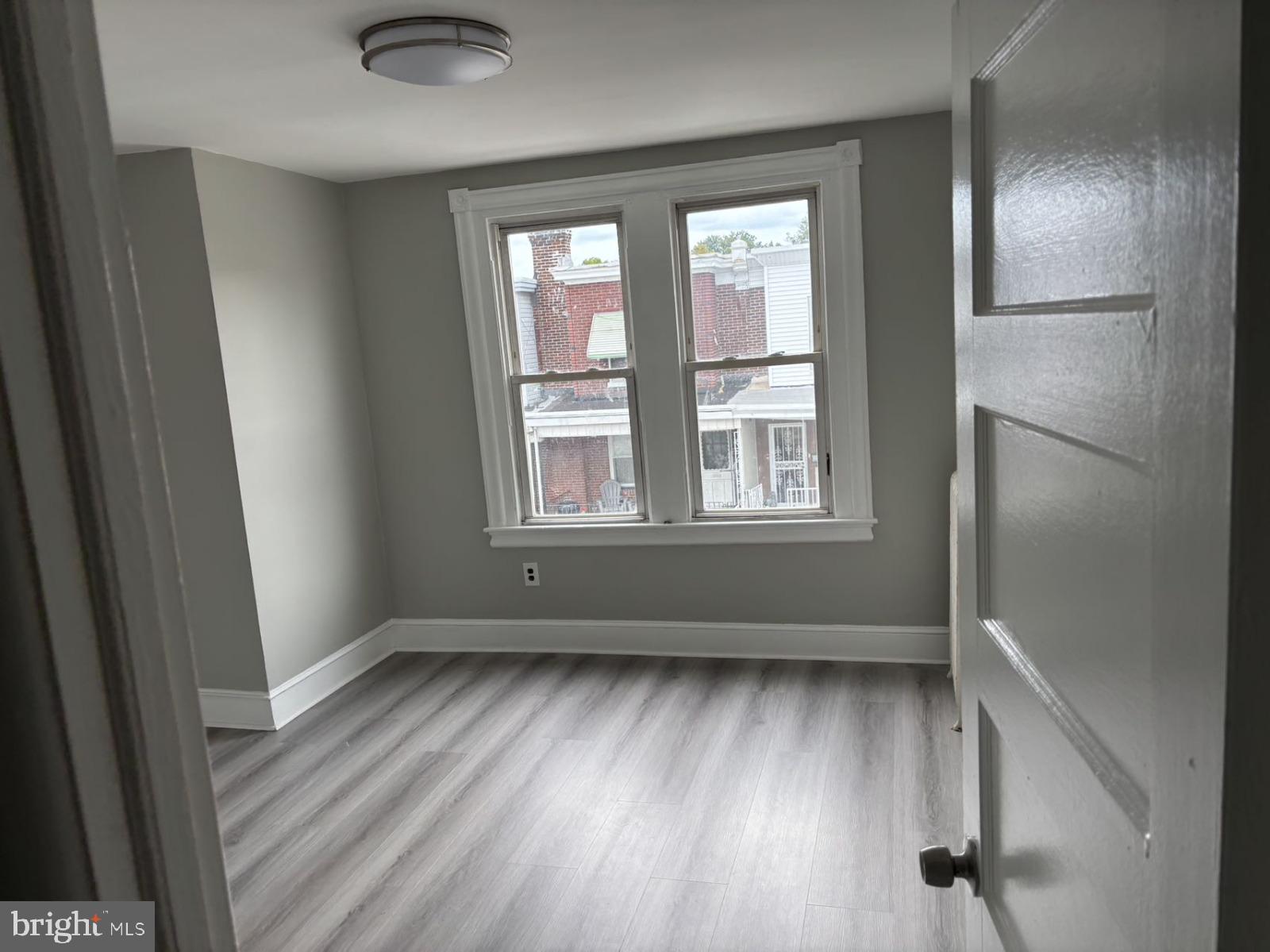 4007 Higbee Street Philadelphia, PA 19135 - Photo 12 of 20 an empty room with wooden floor and windows