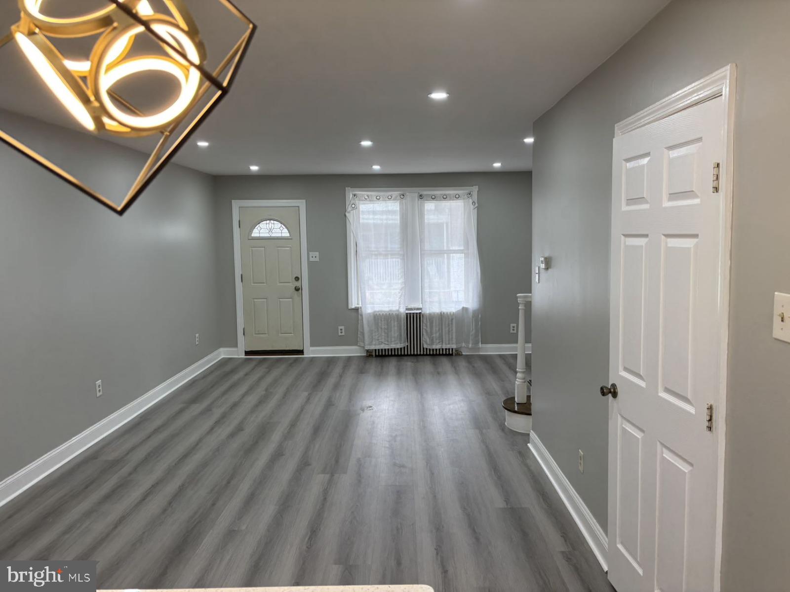 4007 Higbee Street Philadelphia, PA 19135 - Photo 7 of 20 a view of a hallway with wooden floor and cabinets