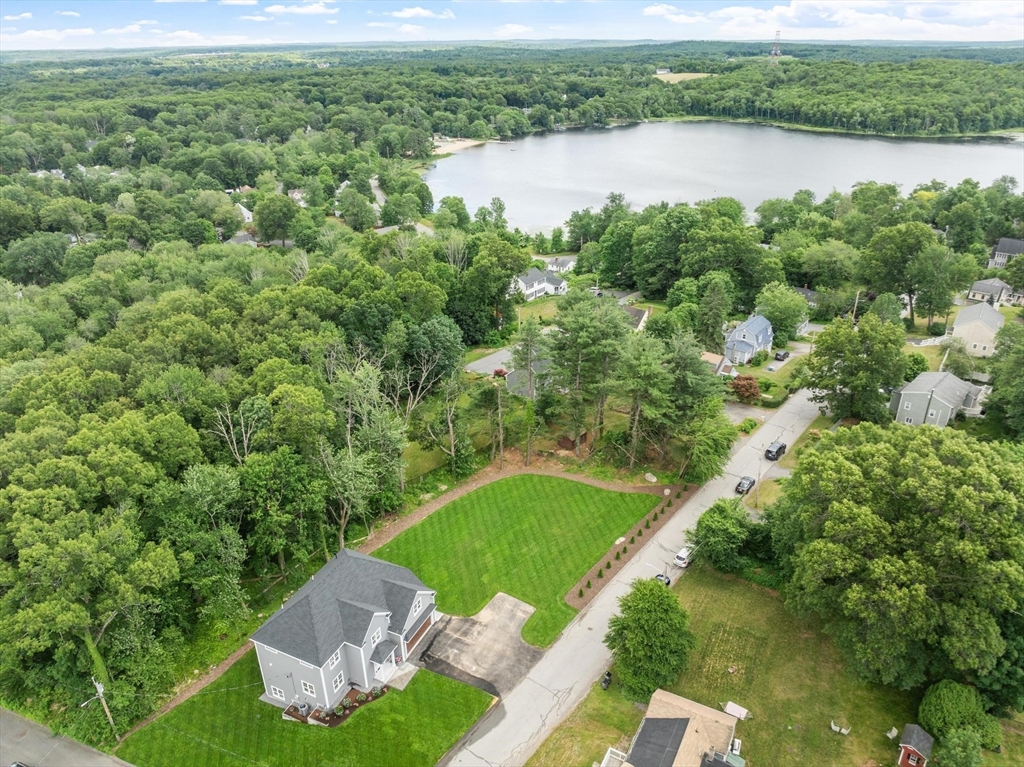 37 Dogwood Road Littleton, MA 01460 - Photo 3 of 36 a view of a lake with a yard and large trees