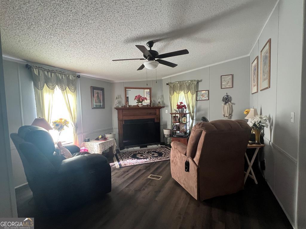 166 Pebble Hills Road Cochran, GA 31014 - Photo 13 of 22 a living room with furniture a fireplace and a flat screen tv