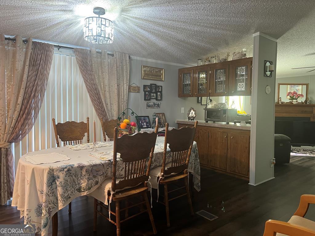 166 Pebble Hills Road Cochran, GA 31014 - Photo 8 of 22 a view of a dining room with furniture and chandelier
