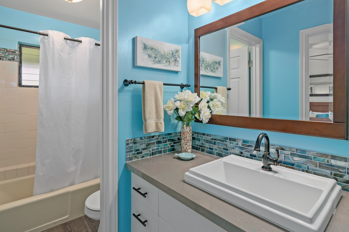 3830 Edward Road, Unit 9F Princeville, HI 96722 - Photo 12 of 20 a bathroom with a sink a toilet and shower