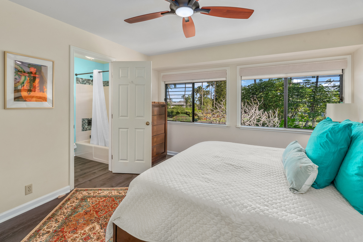 3830 Edward Road, Unit 9F Princeville, HI 96722 - Photo 17 of 20 a bedroom with a bed and a large window