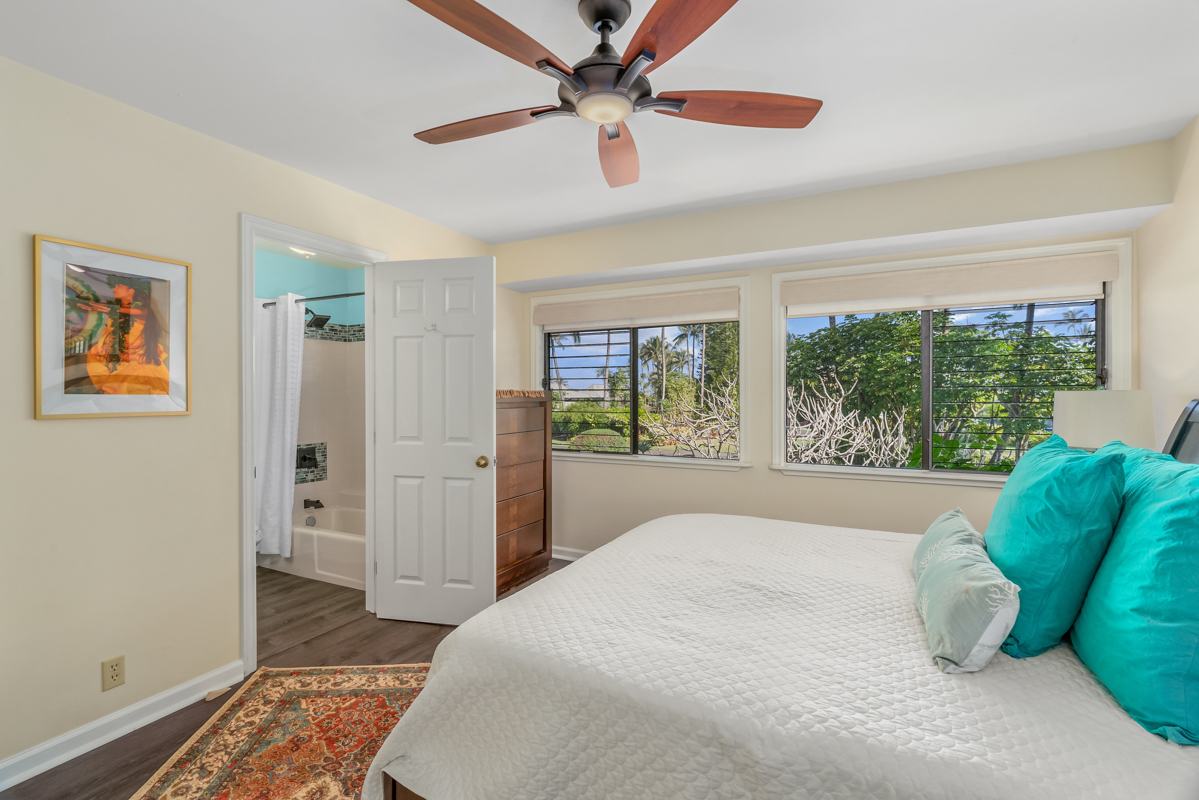 3830 Edward Road, Unit 9F Princeville, HI 96722 - Photo 20 of 20 a bedroom with a bed and a large window