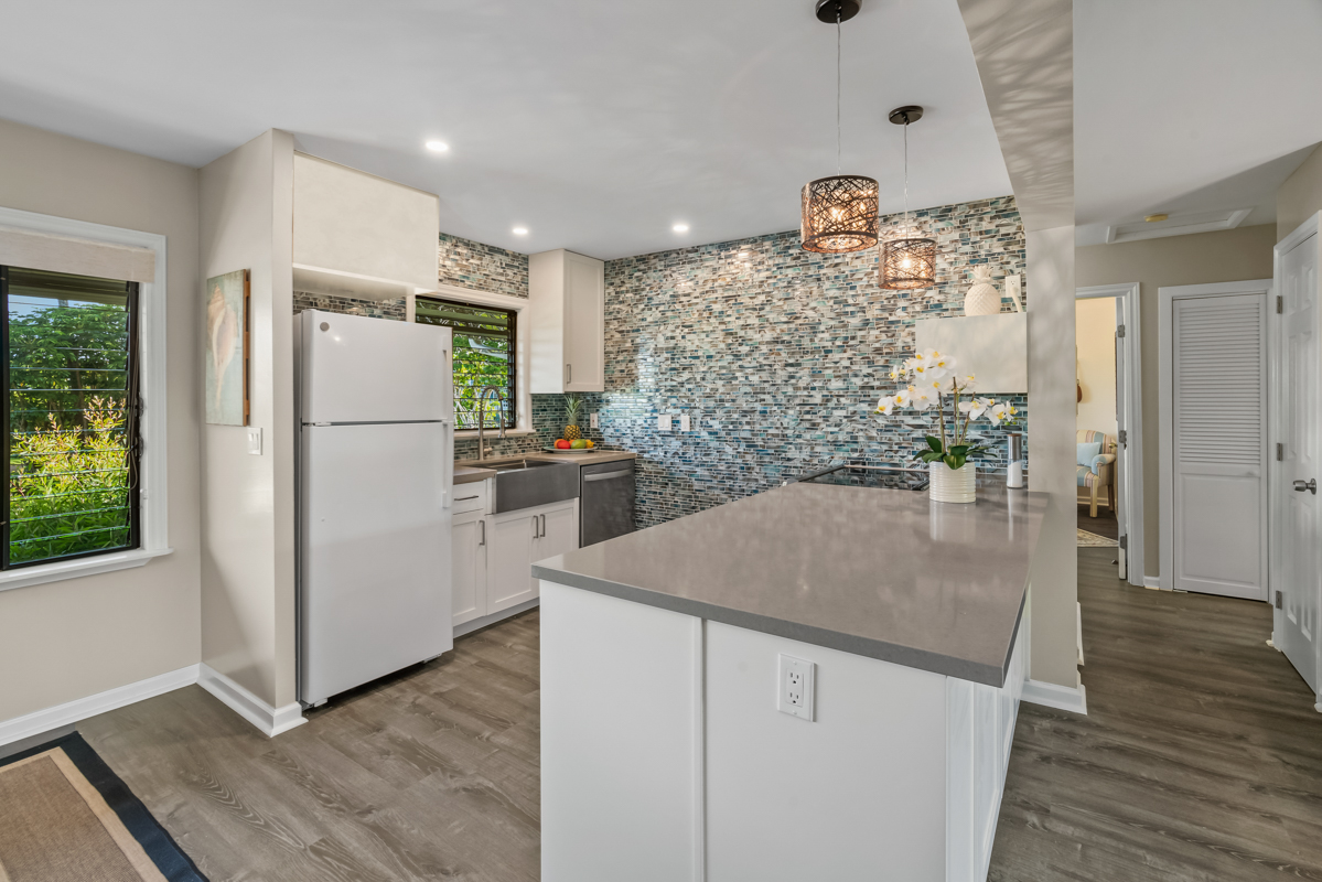3830 Edward Road, Unit 9F Princeville, HI 96722 - Photo 3 of 20 a kitchen with refrigerator and cabinets