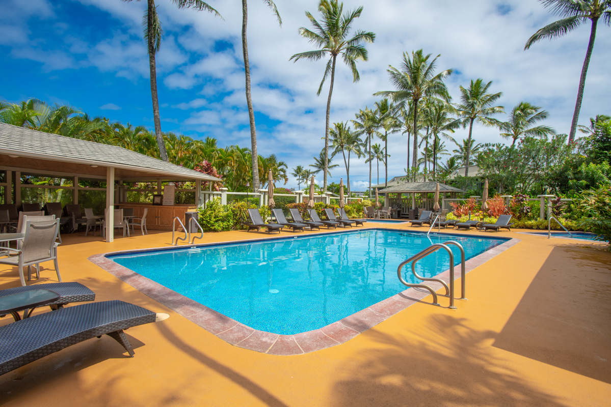 3830 Edward Road, Unit 9F Princeville, HI 96722 - Photo 6 of 20 a view of a swimming pool with lounge chair