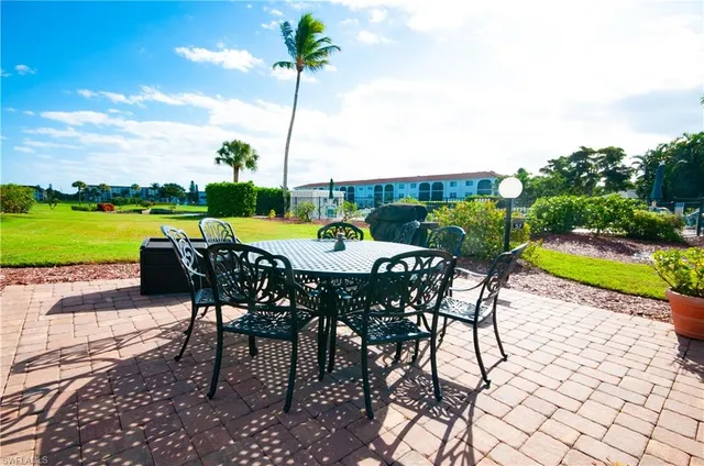 a view of a roof deck with furniture and a yard