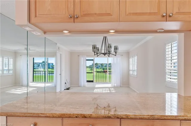 a view of a kitchen with a sink and window