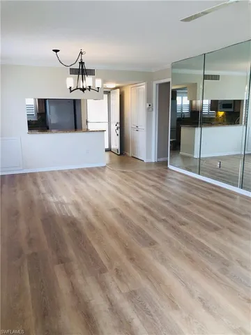 a view of a kitchen with a sink and a refrigerator