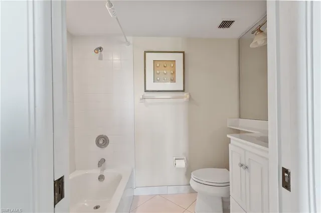 a white toilet sitting next to a bathroom sink
