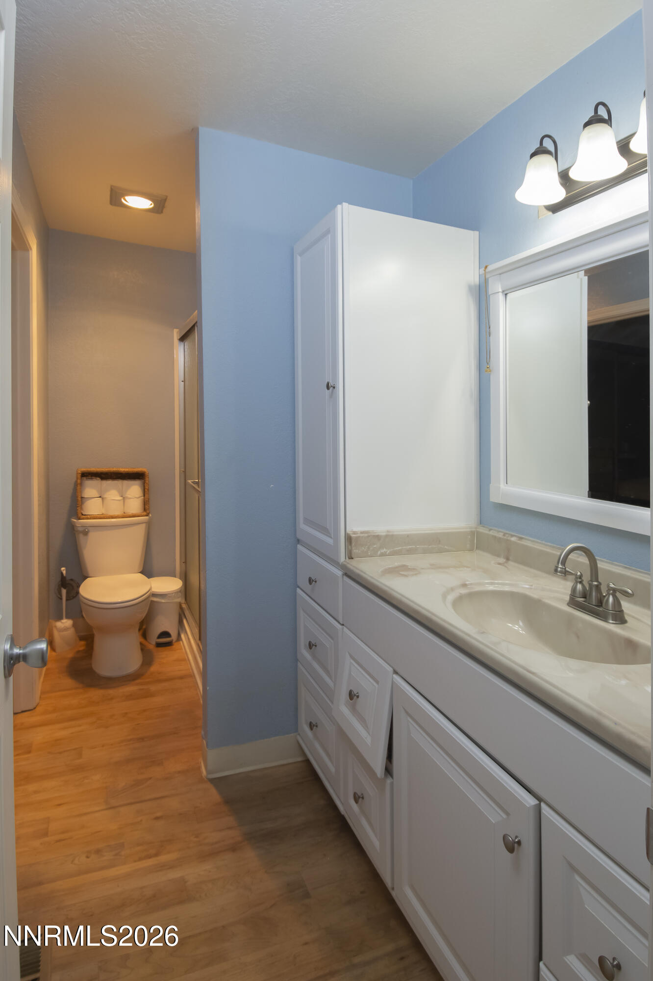 2317 Roundhouse Road Sparks, NV 89431 - Photo 14 of 14 a bathroom with a granite countertop sink and a mirror