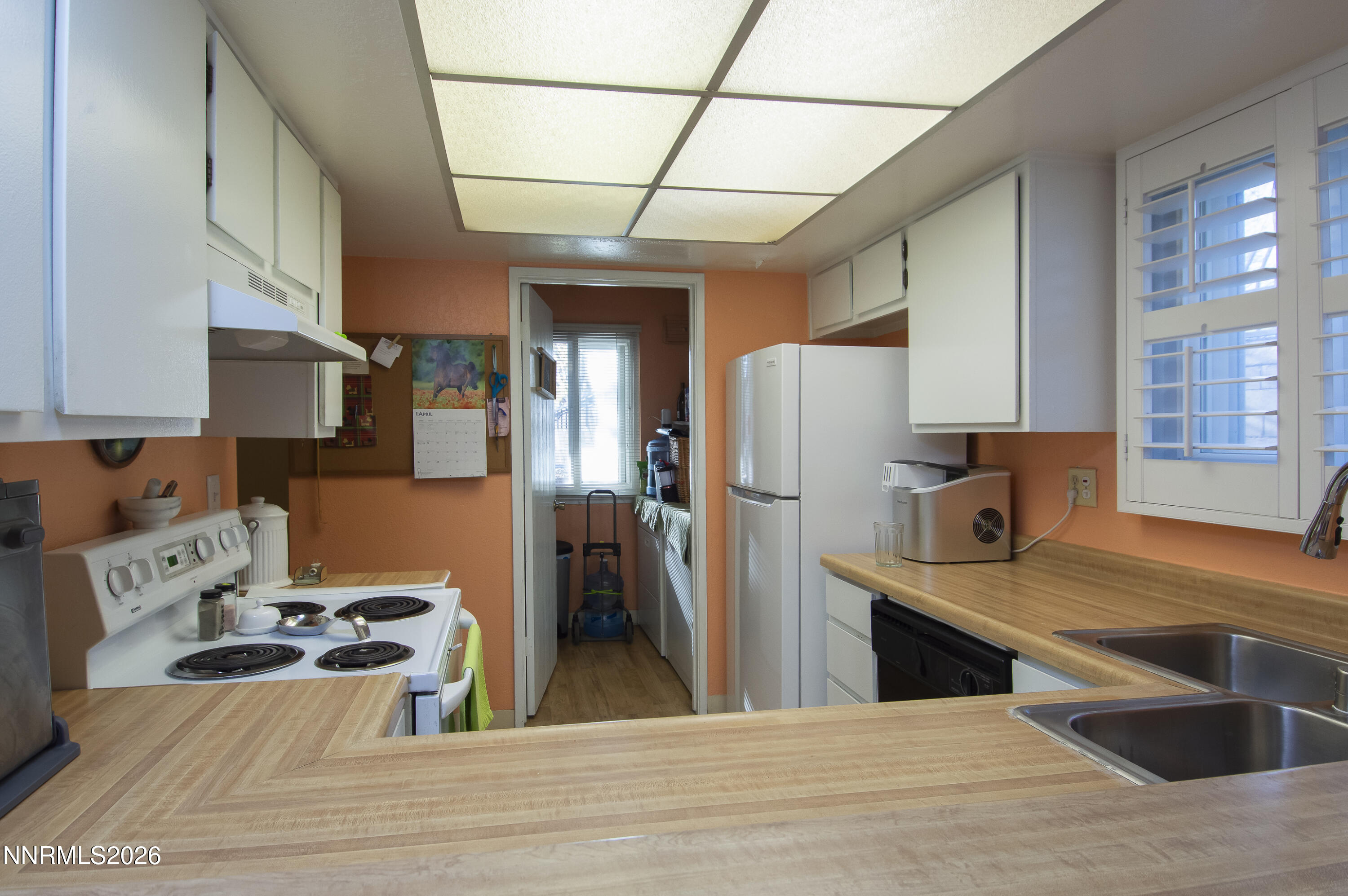 2317 Roundhouse Road Sparks, NV 89431 - Photo 8 of 14 a kitchen with stainless steel appliances granite countertop a refrigerator a sink dishwasher a stove and white countertops with wooden floor