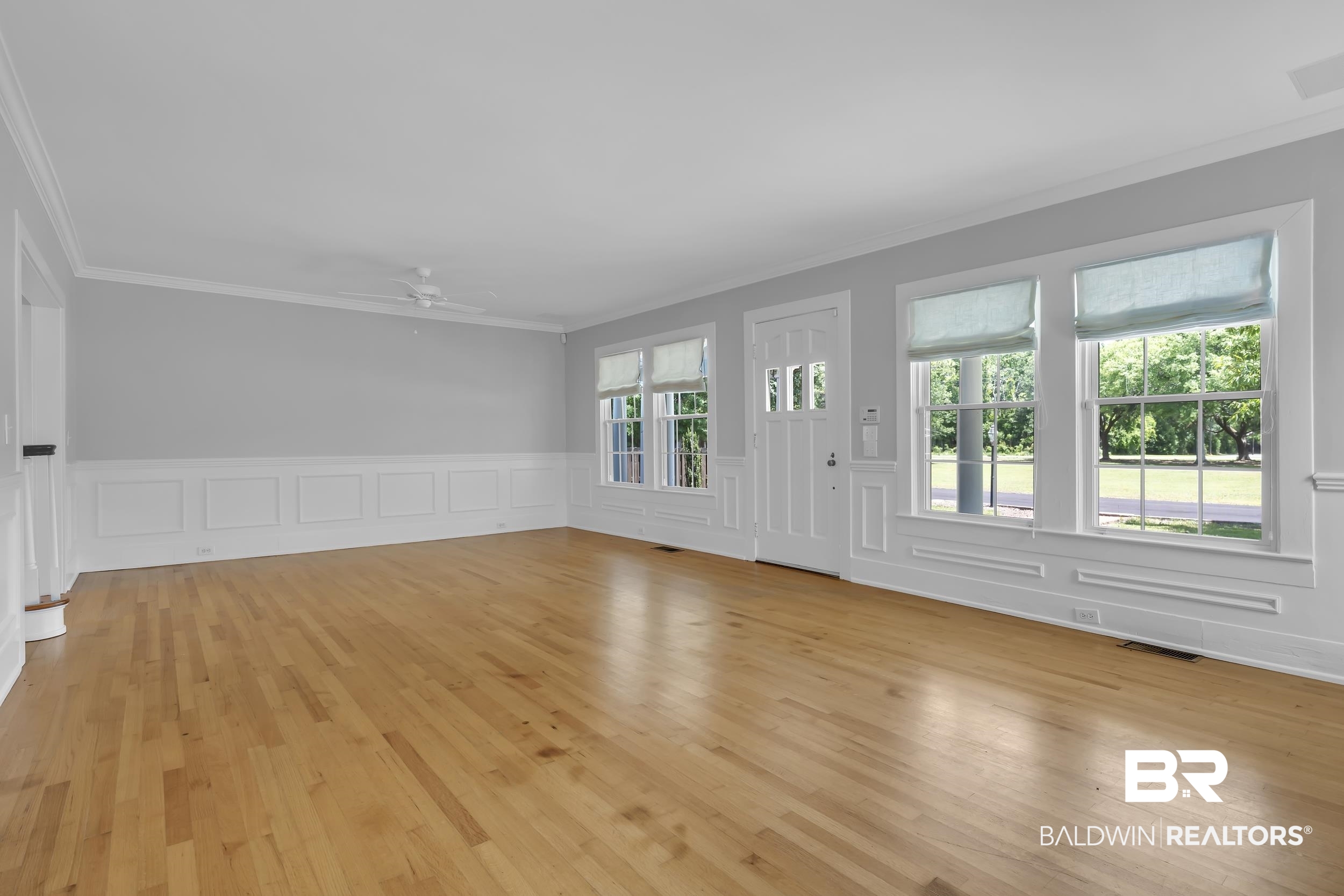 43199 Pine Grove Road Bay Minette, AL 36507 - Photo 31 of 71 Spacious room featuring hardwood flooring, wainscoting, crown molding, and multiple windows with natural light