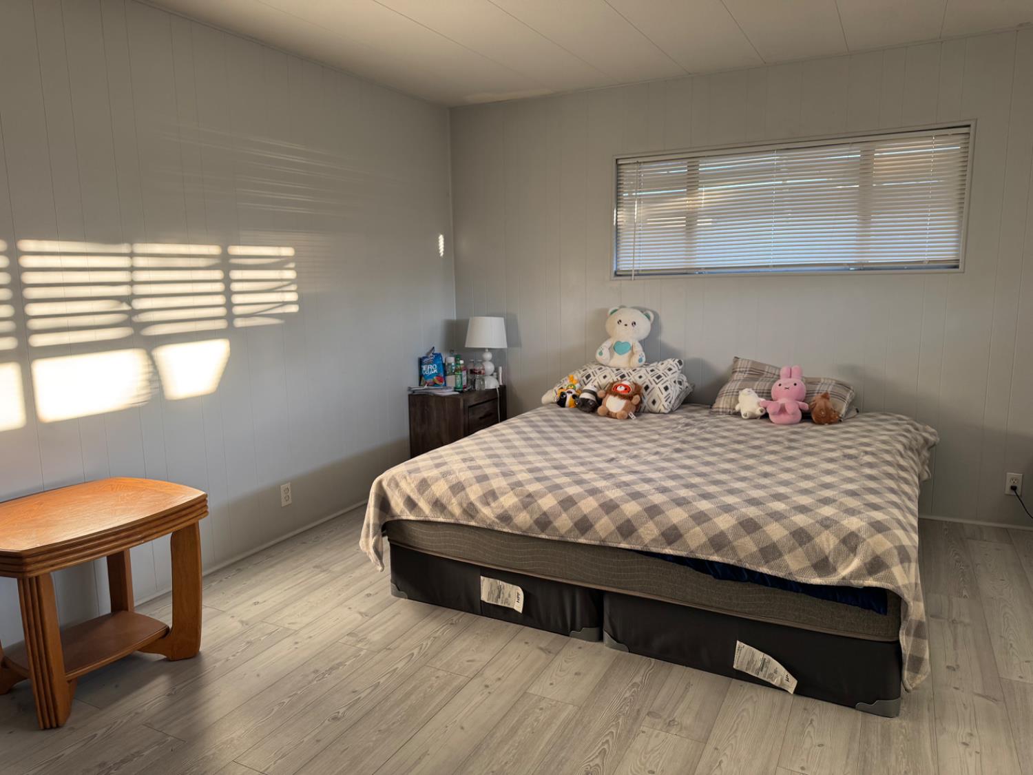 10035 Mills Station Road, Unit 161 Sacramento, CA 95827 - Photo 11 of 15 a bedroom with a bed a lamp and a window